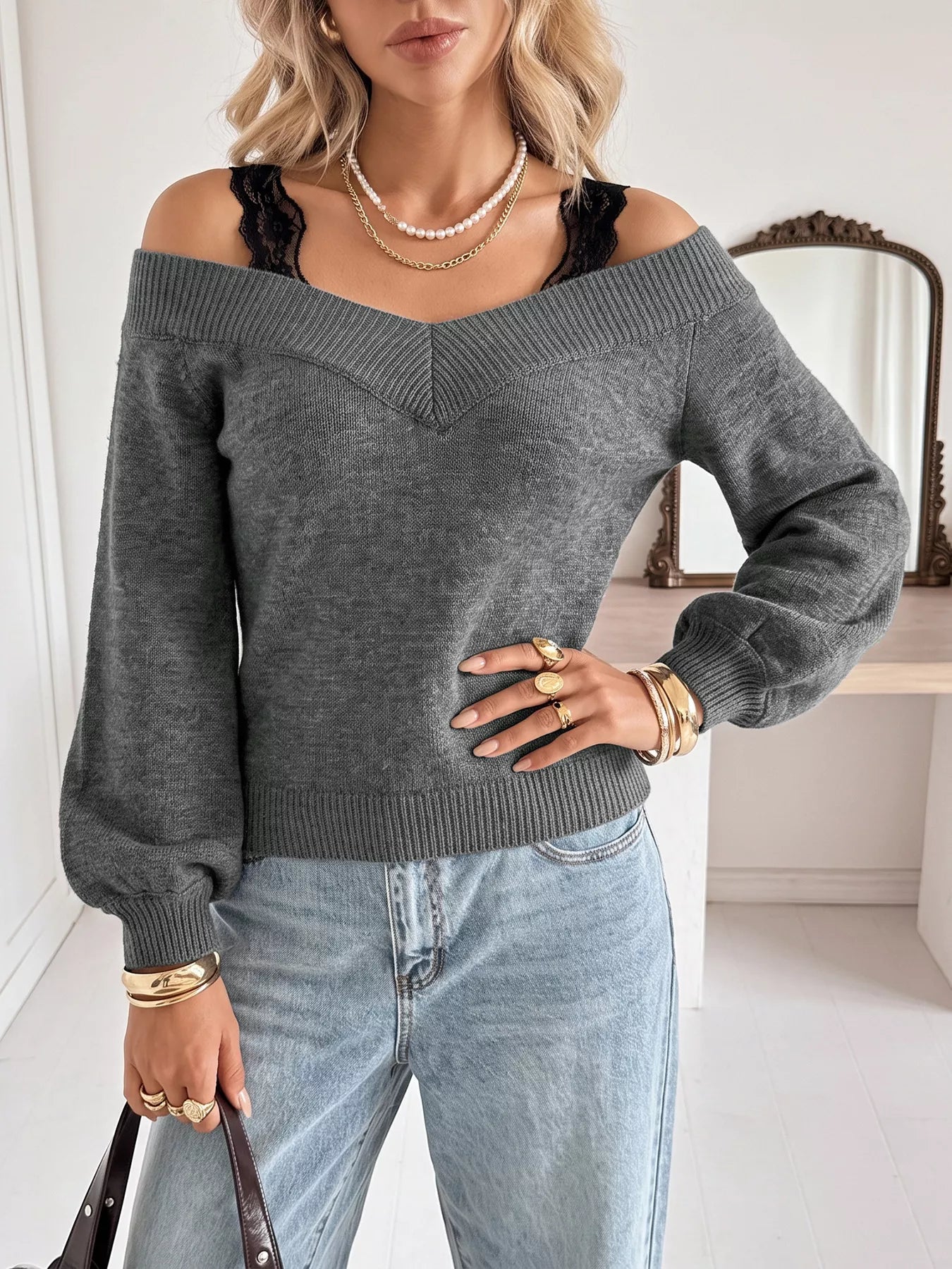 Dark grey off shoulder lace trim sweater shown front on with light jeans