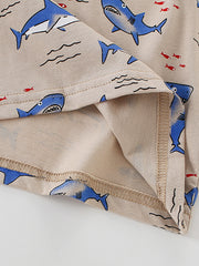 Detail view of the folded hem and inner stitching on a children's shark print crew neck t-shirt
