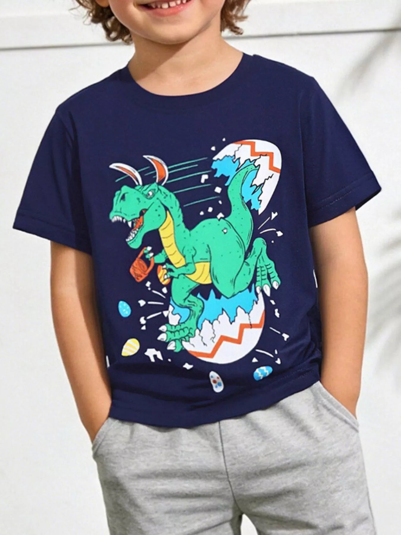Children's dark navy crew-neck T-shirt featuring a dinosaur graphic.