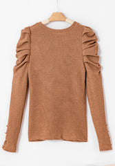 Blusa con cuello redondo, mangas abullonadas y botones decorativos