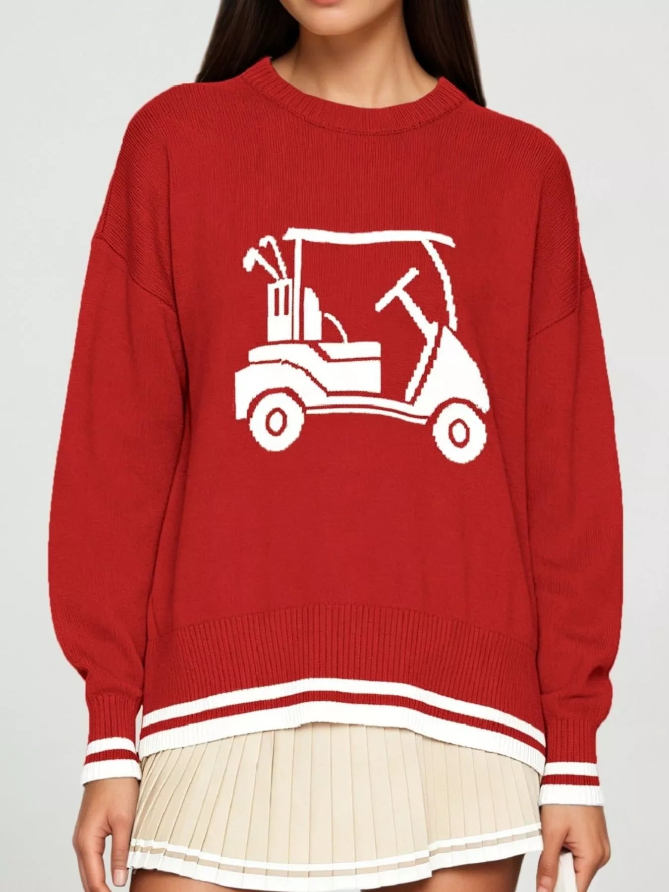 Front view of a red dropped shoulder sweater with a white golf cart graphic and striped trim.