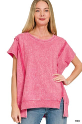 Women's pink oversized hi-low top with short sleeves, ribbed neckline and hem, side slits, and washed finish.