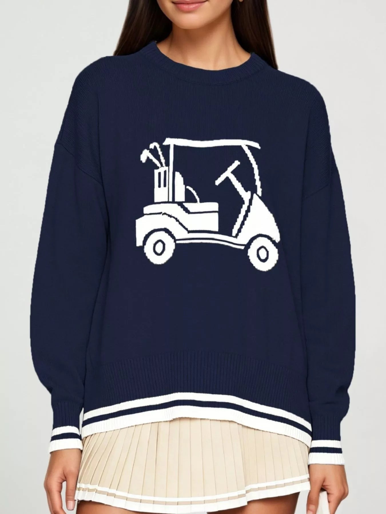Front view of a navy dropped shoulder sweater with a white golf cart graphic and striped trim.