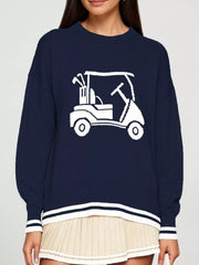 Front view of a navy dropped shoulder sweater with a white golf cart graphic and striped trim.