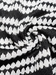 Close up fabric detail of a black and white striped knit dress showing the knit texture
