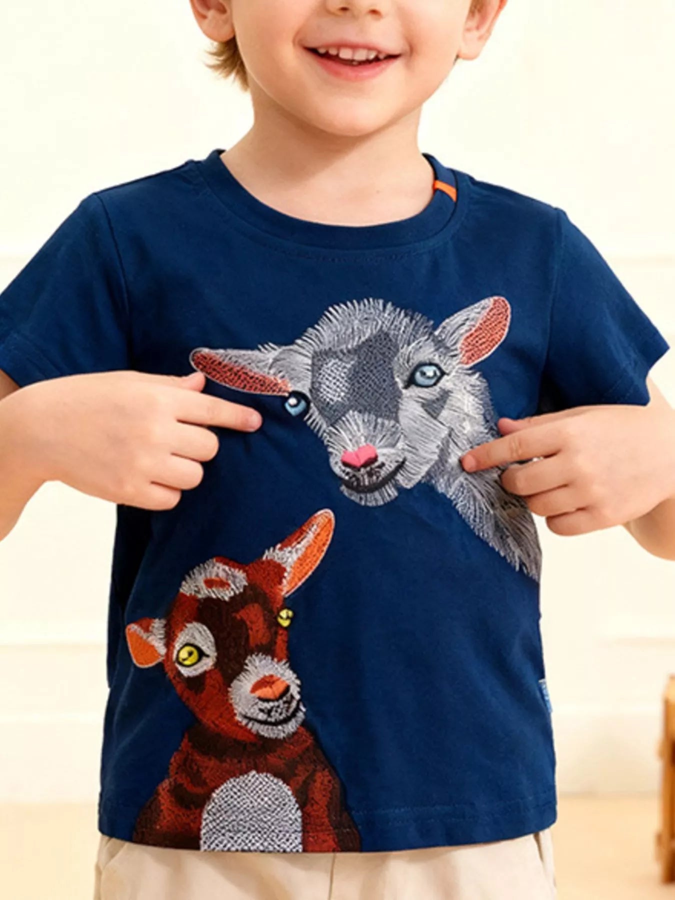 Children's dark blue round-neck tee featuring an embroidered goat design.