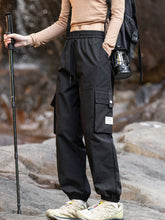 Men's black loose-fit cargo pants with a drawstring waist and pockets.