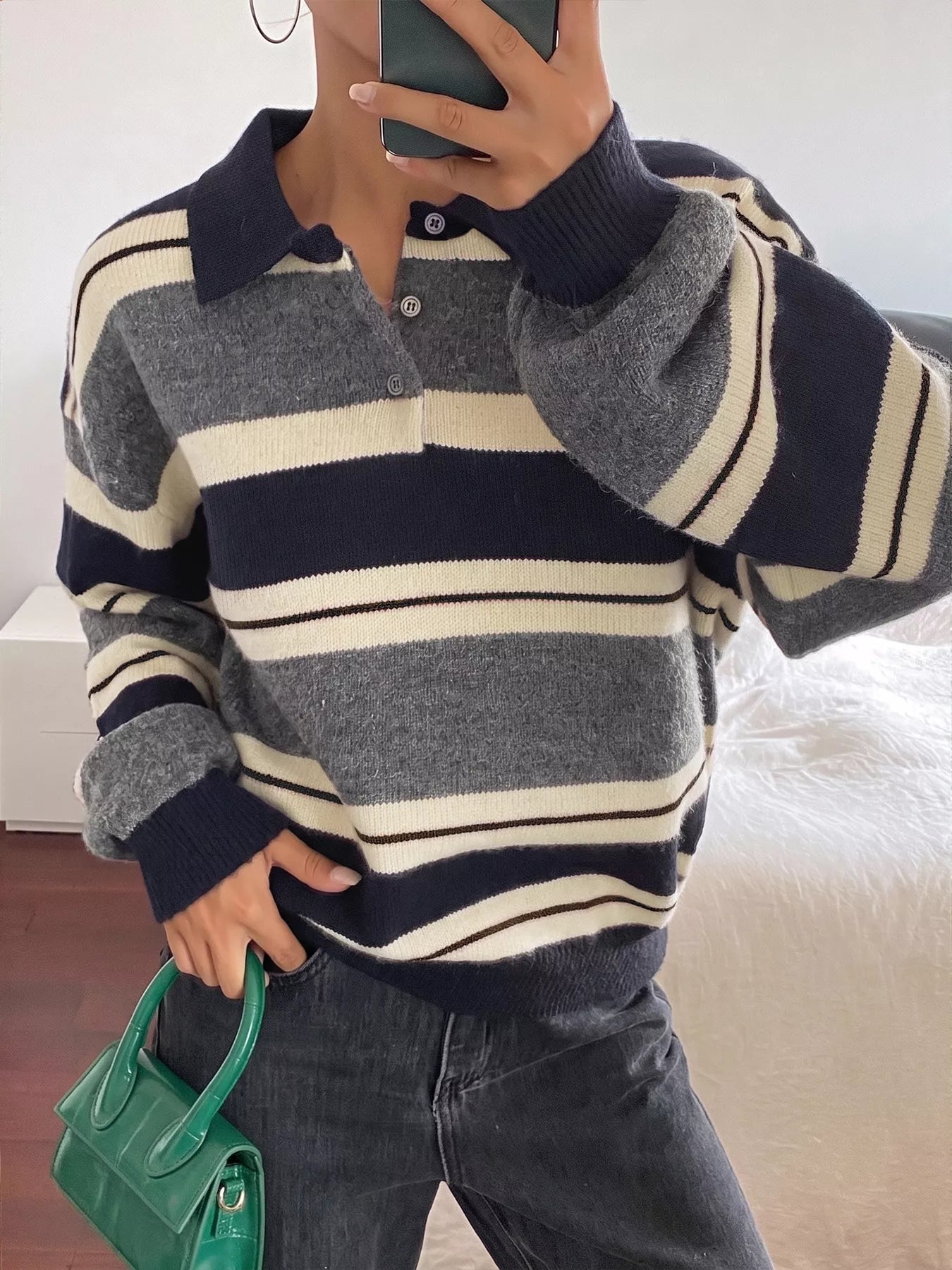 On-model front view of the striped polo sweater with its button placket partly open