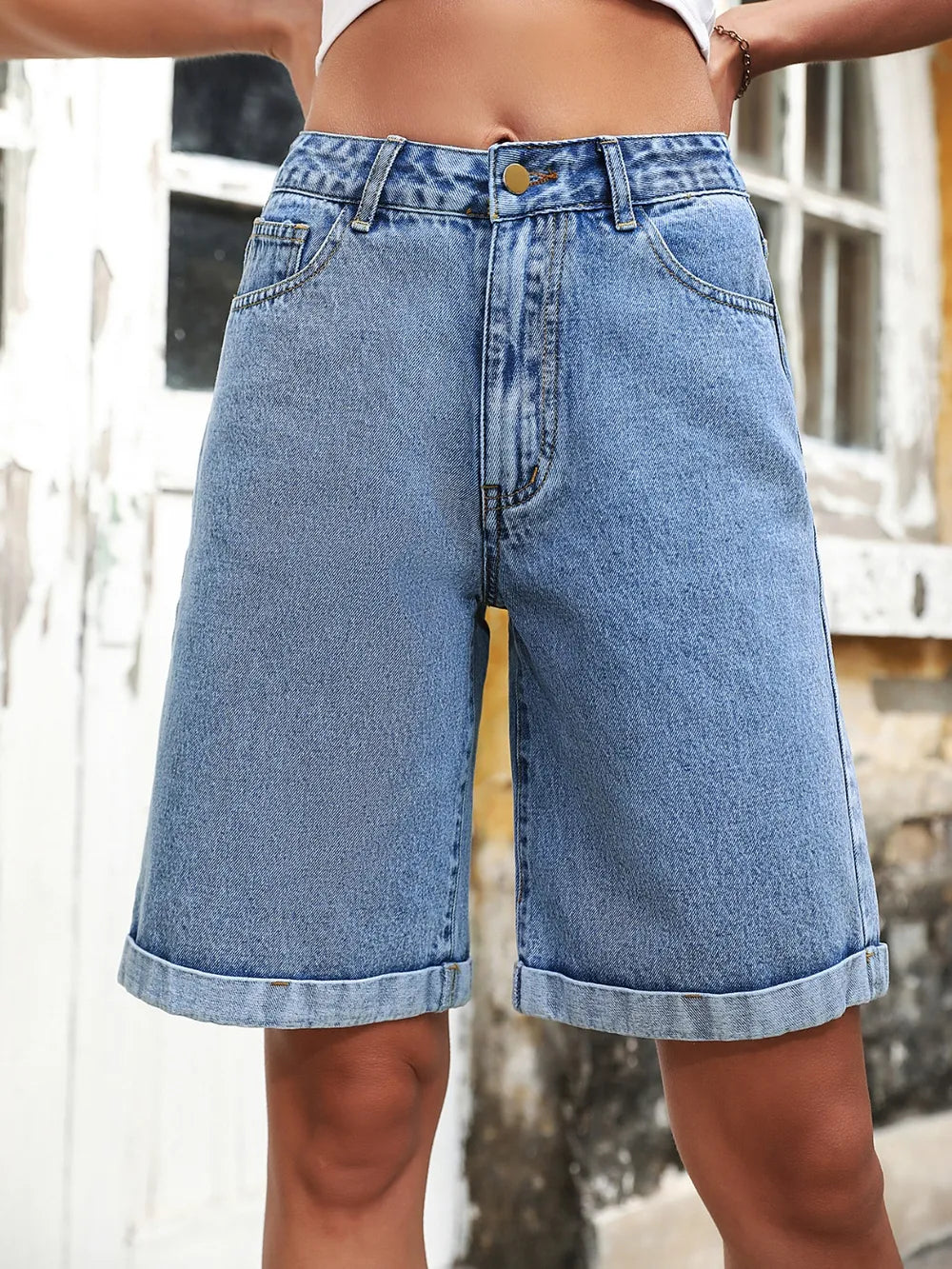 Women's high-waisted denim shorts with buttons and pockets in a non-stretch cotton blend.