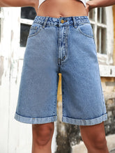 Women's high-waisted denim shorts with buttons and pockets in a non-stretch cotton blend.