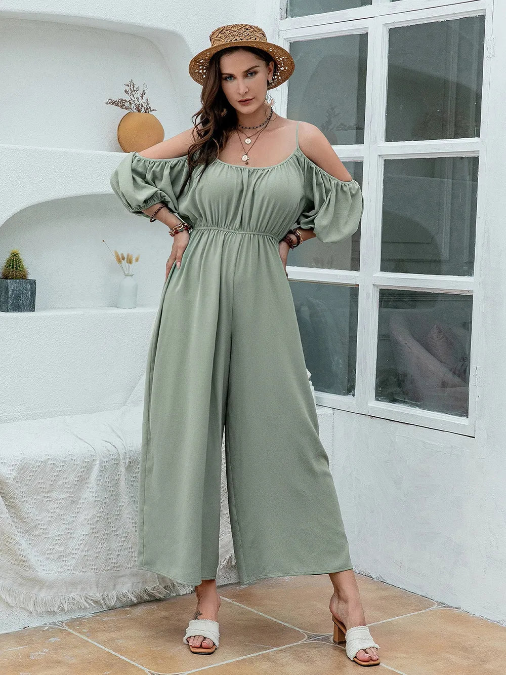 Women's sage jumpsuit with spaghetti straps and wide legs.