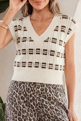 Front view of cream geometric knit vest with brown pattern and V neckline.