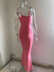 Back view of a burnt coral spaghetti strap bodycon maxi dress on a clear mannequin showing the straps