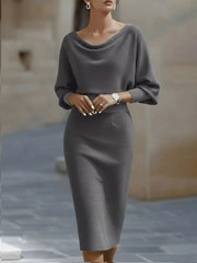 Front view of a gray cowl neck bodycon midi dress with three quarter sleeves outdoors