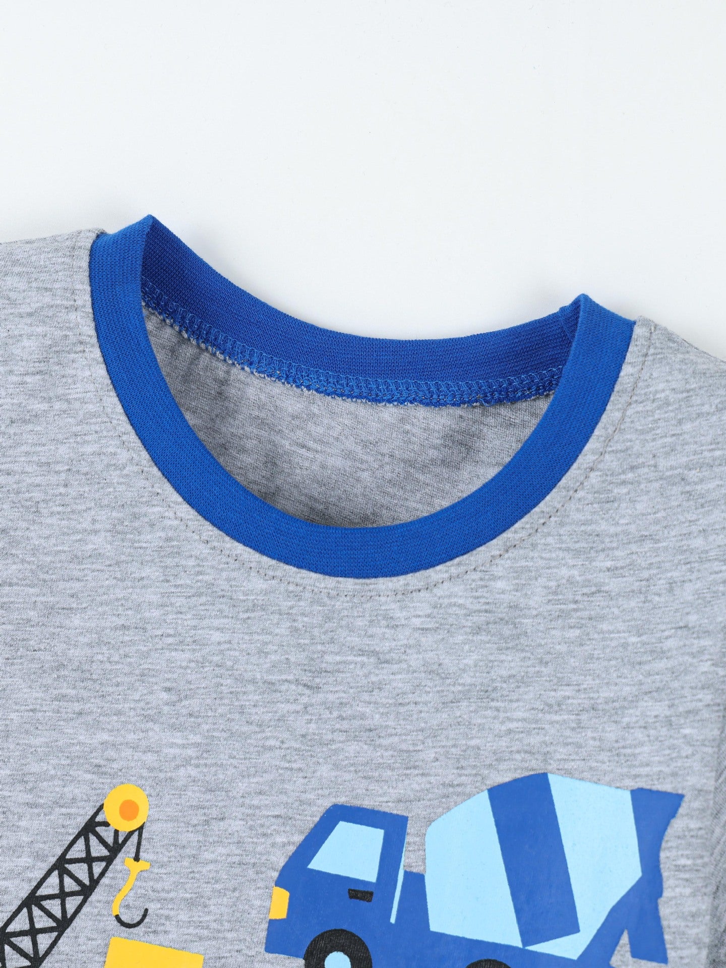 Close-up of gray children's t-shirt neckline with bright blue ribbed collar and stitching