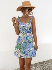 Women's blue printed mini dress with ruffles, a surplice neckline and wide straps.