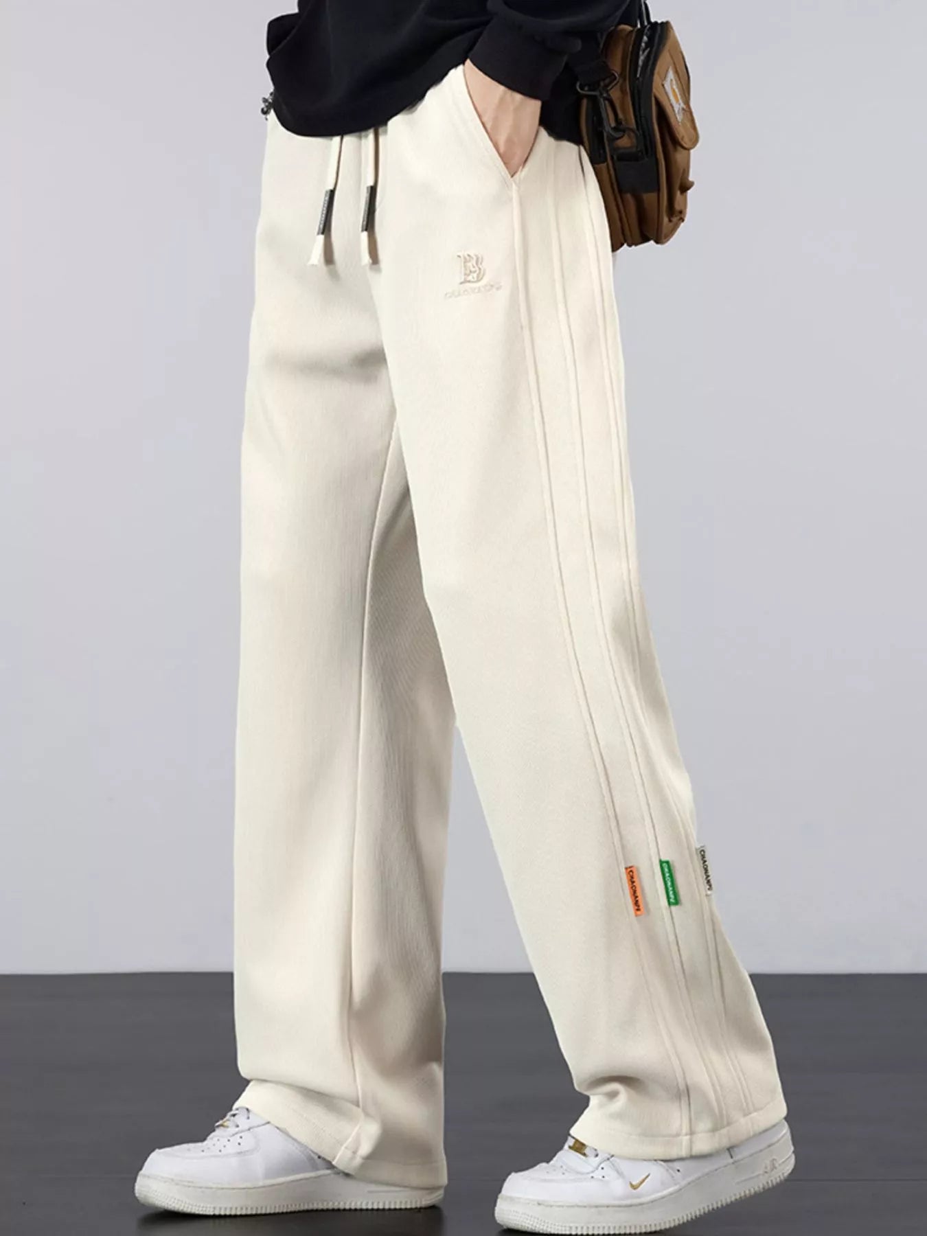 Men's casual loose fit pants with a drawstring waist and pockets.