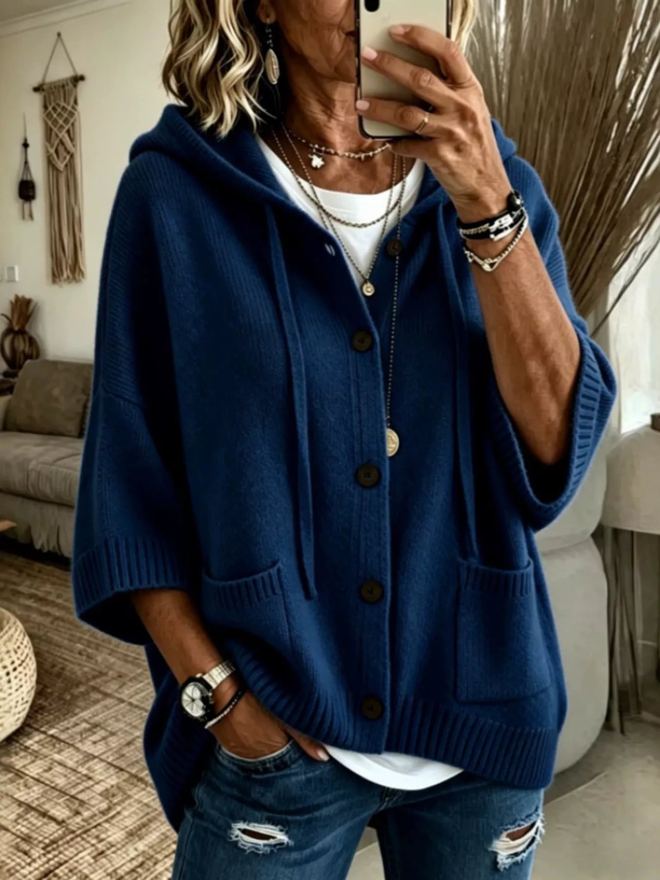 Navy hooded knit cardigan with brown buttons and patch pockets shown from the front on model