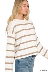 Side view of cream and mocha striped sweater with long wide sleeves.