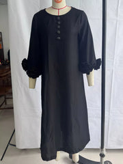 Black round neck midi dress displayed on a mannequin with floral cuffs and small floral buttons, front view