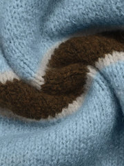 Close up of soft blue and brown striped knit texture with cream edging.