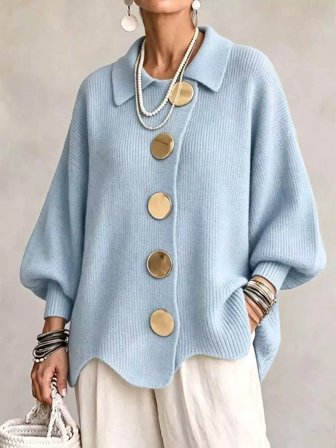 Front view of a sky blue knit cardigan with large gold buttons