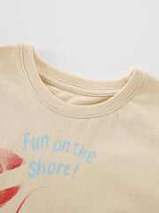 Close-up of the round neckline and stitching on the children's apricot lobster tee