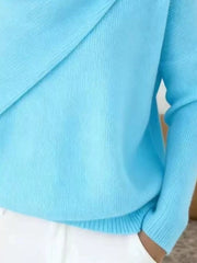 Close-up of the light blue sweater lower body and long sleeve showing the ribbed hem and knit texture