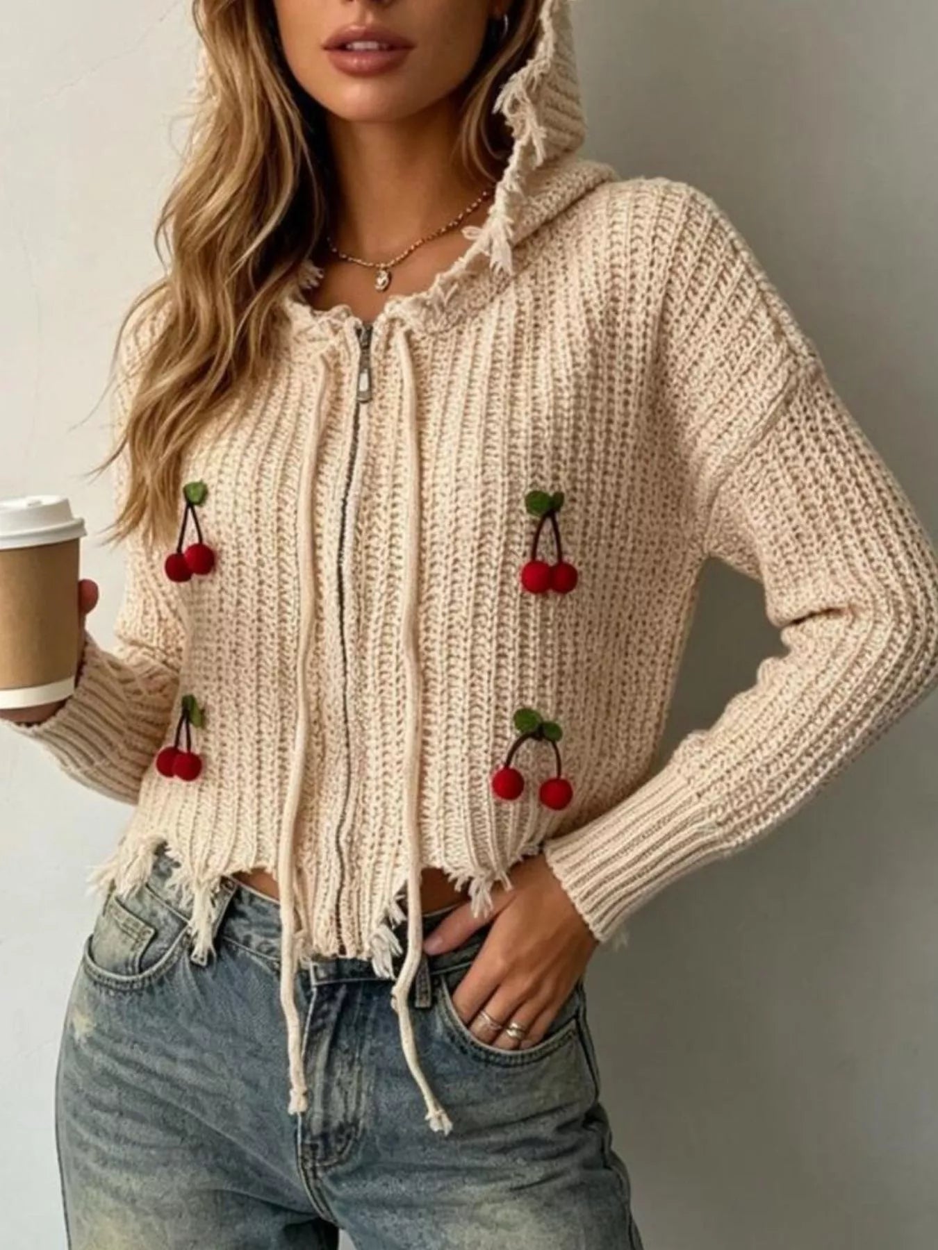Apricot knit zip up hooded sweater with hood up and red cherry appliques, close torso view