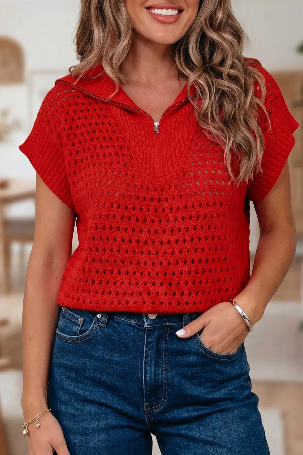 On-model front view of a red openwork quarter zip knit top with short sleeves