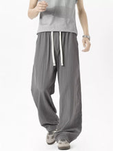 Men's lightweight loose fit casual pants with a drawstring waist.