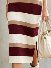 Closeup of burgundy striped sweater dress skirt showing ribbed knit and side slit