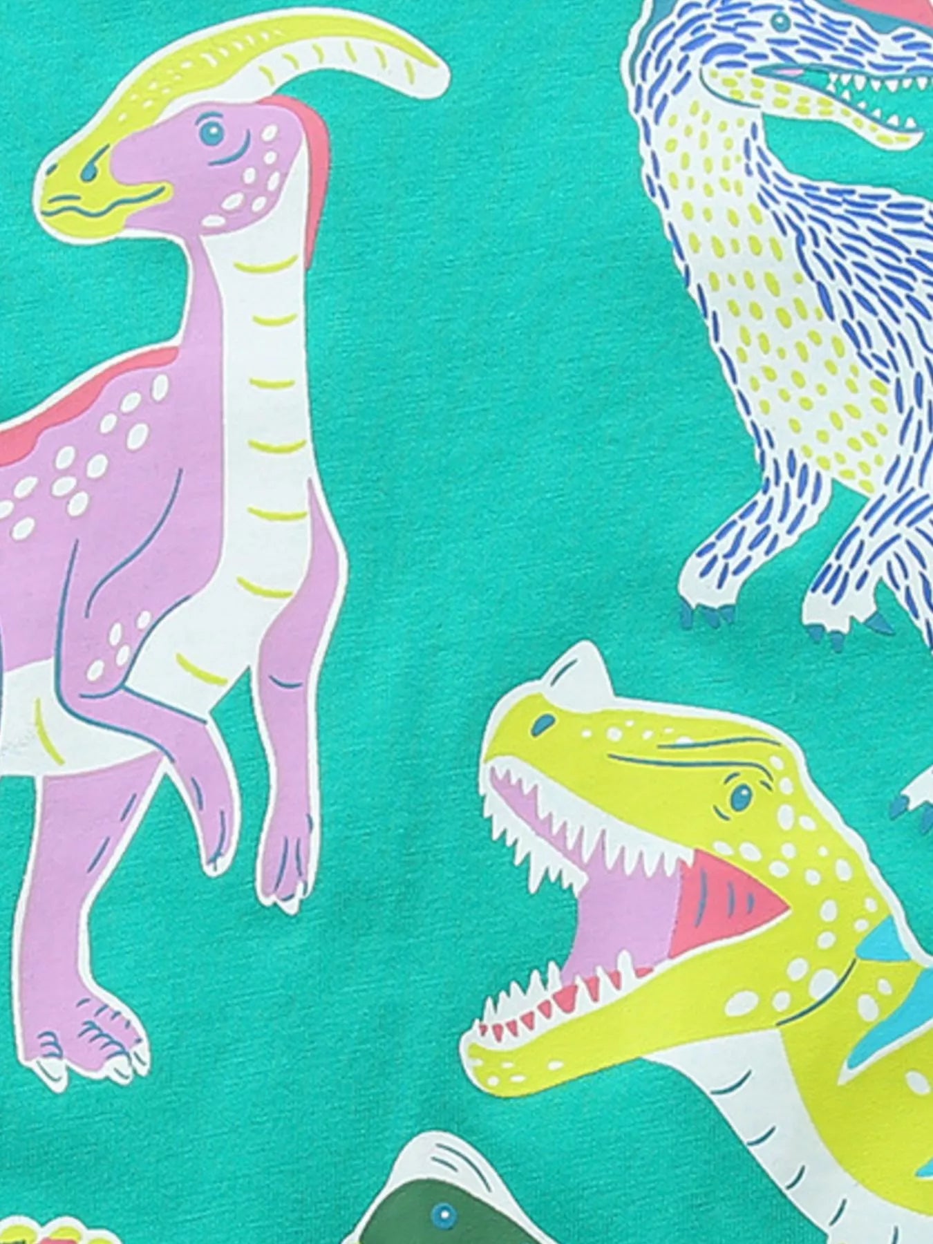 Close-up of colorful dinosaur prints on turquoise children's short sleeve t-shirt fabric