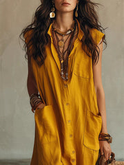 Close view of gold sleeveless button down linen maxi dress showing buttons and large pockets