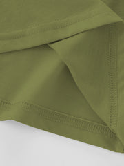 Close view of the moss green children's tee hem and side seam showing fine overlock stitching
