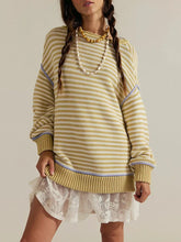 On-model front view of a yellow and white striped oversized sweater with dropped shoulders