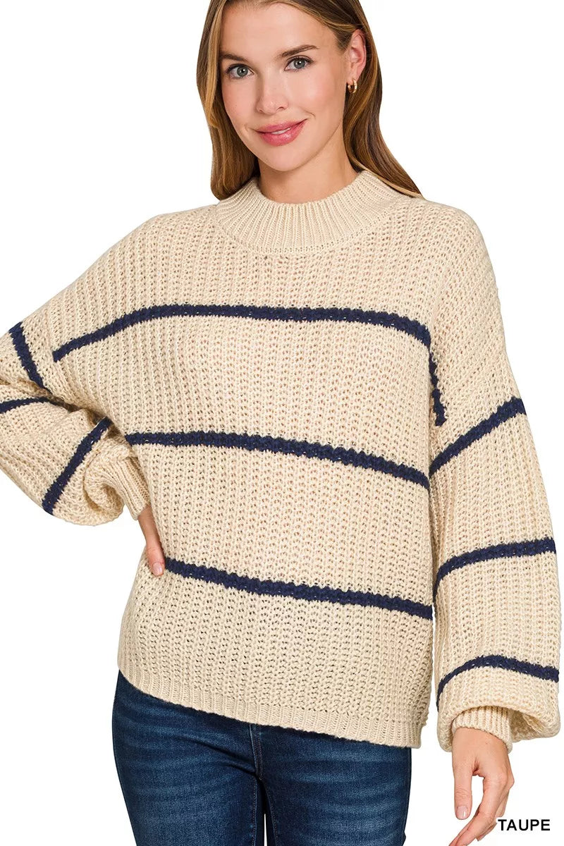 Front view of cream oversize striped sweater with navy stripes and dark jeans