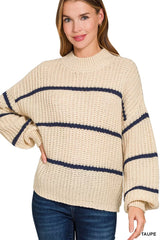 Front view of cream oversize striped sweater with navy stripes and dark jeans