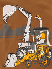 Detail view of dinosaurs driving excavators against gray mountains on a children's brown t-shirt