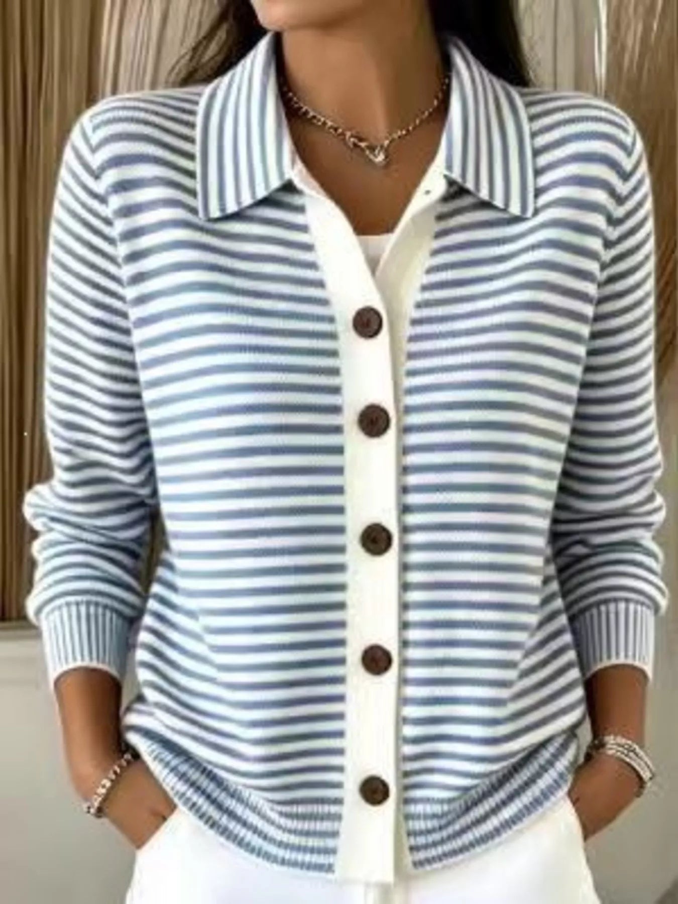 On-model front view of a blue and white striped button-down knit cardigan with a collar