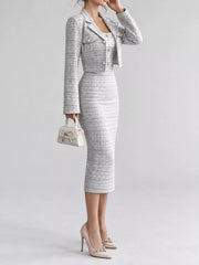 Side view of black and white tweed dress and cropped cardigan with small handbag