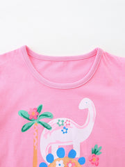 Close up of pink children's t-shirt round neckline with white dinosaur and palm tree print
