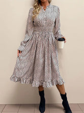 Women's leopard-print dress with long sleeves, ruched detailing and ruffles.