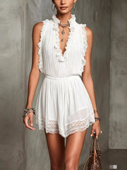 Front view of white sleeveless mini dress with pleated bodice and lace hem