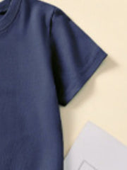 Close-up of the short sleeve and shoulder seam on a dark navy children's T-shirt