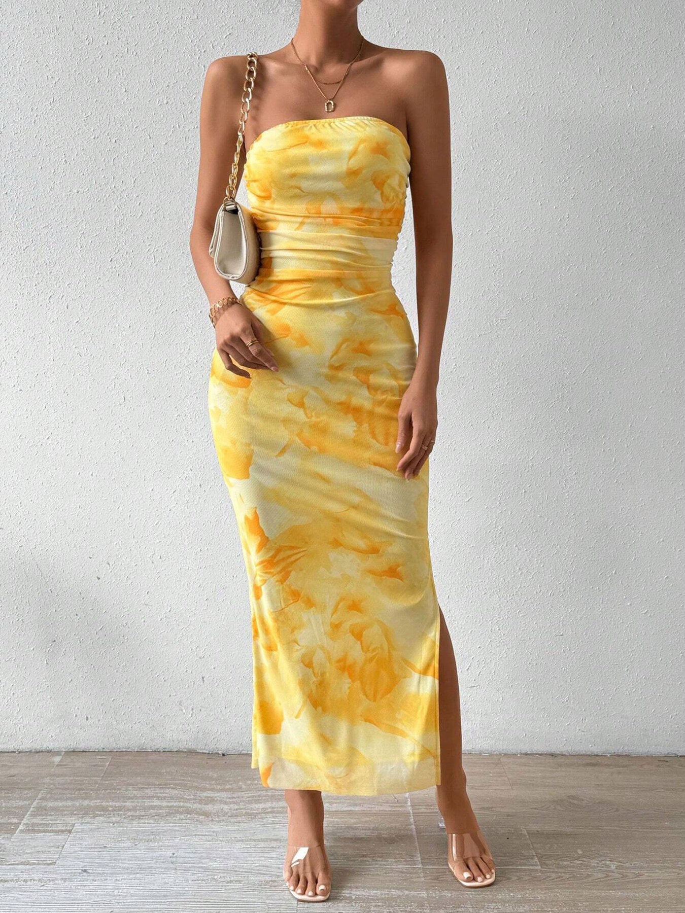 Yellow ruched strapless bodycon midi dress with abstract print and side slit, front view