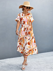 Women's orange-red A-line midi dress with a round neckline, short sleeves and tie waist.