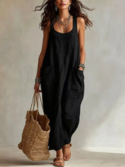 Model wearing black sleeveless scoop neck maxi dress, full view with large front pockets