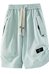 Men's sage lightweight shorts with a drawstring waist and pockets.