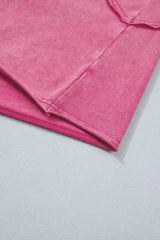 Close-up of pink cap sleeve top showing raw seam details and lace-trimmed hem.